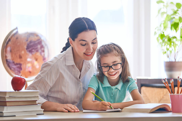 Happy family. Mother and daughter are learning to write. Back to school. - Foto, imagen