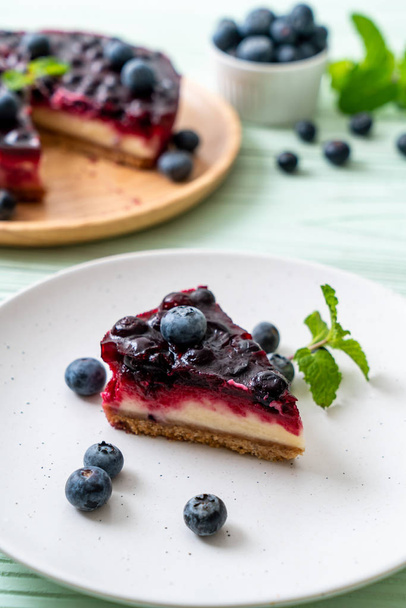 homemade blueberry cheese cake on wood background - Foto, afbeelding
