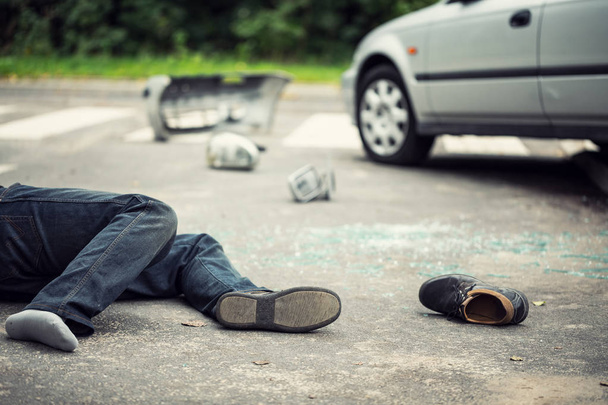 Person without a shoe hit by a car on the road. Drunk driving concept. Blurred background - Valokuva, kuva