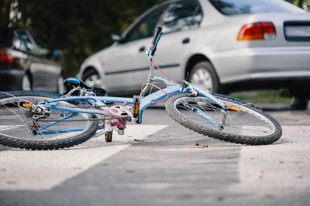 Kid's bike on a pedestrian crossing after dangerous incident with a car - Photo, image