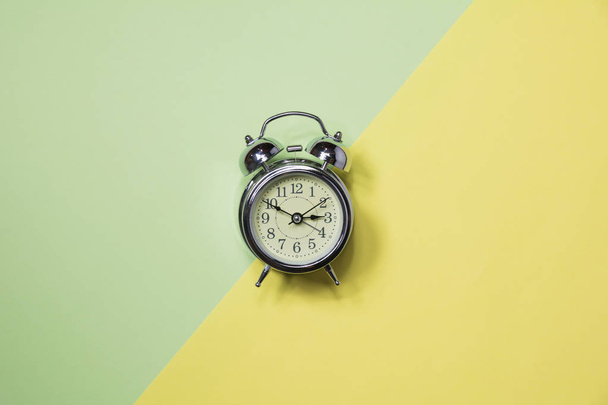 Top view of alarm clock on colorful background and copy space for insert text. - Foto, Imagen