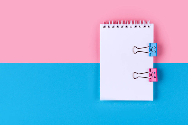 Top view of Blank notebook on colorful background pink blue with copy space. - Фото, зображення