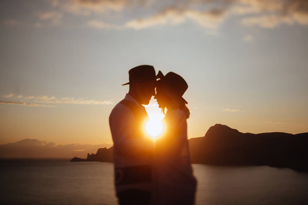 Romantic summer love story on a sunset in mountains. Young girl and boy in love. - Foto, immagini
