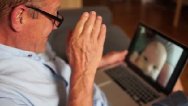 Mature man talks to his adult son and newborn grandson on Skype. Video communication, three generations of one family - Felvétel, videó
