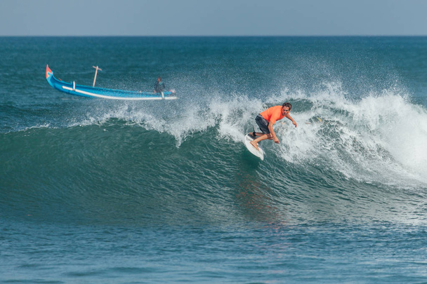 Surfer riding big green wave at Padang Padang beach, Bali, Indonesia - Photo, Image