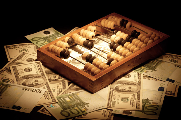 Old abacus on dollars and euro backgroun - Фото, зображення
