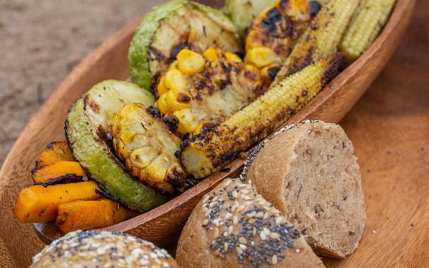 decomposed the grilled vegetables with bread into a wooden plate on old gray wood - Fotografie, Obrázek