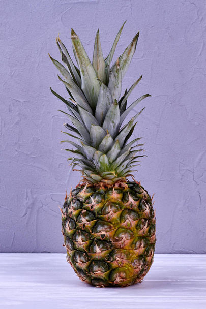 Fresh pineapple on wooden background. - 写真・画像