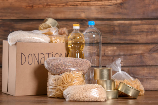Donation box with food on wooden background - Photo, image