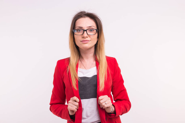 Portrait of beautiful young woman wearing red jacket and glasses. - Foto, immagini
