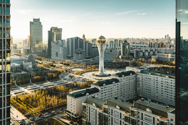 Sunset view towards Bayterek tower and hous of ministries in Astana Kazakhstan on a clear day - Photo, Image