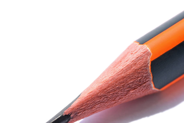 Isolated graphite simple pencil with orange and black pen on white background close-up - Photo, Image