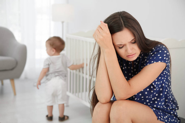 Young mother suffering from postnatal depression and little baby in room - Zdjęcie, obraz