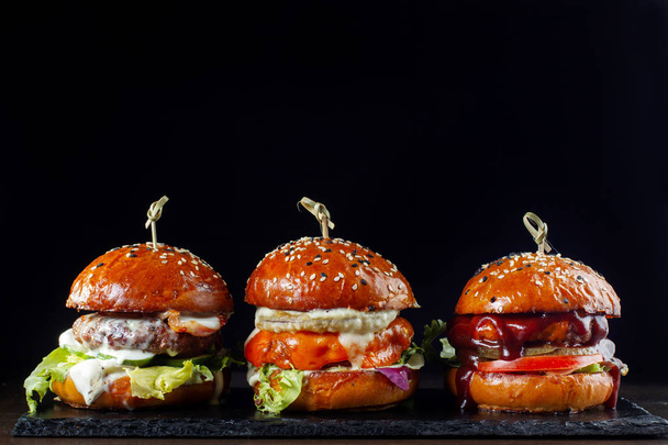 Set burgers with beef. On a black background-2 - Foto, Imagem