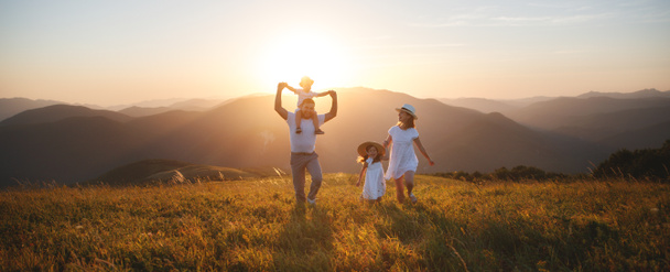 Happy family: mother, father, children son and  daughter on nature  on sunset - Photo, Image