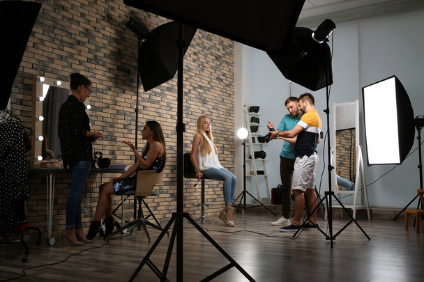Professional team working with model in photo studio - Фото, изображение