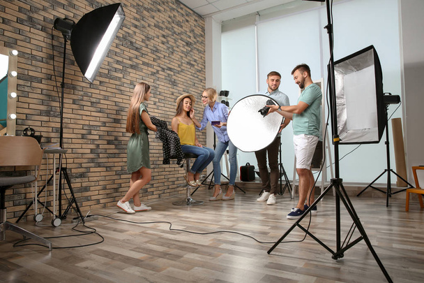 Professional team working with model in photo studio - Fotoğraf, Görsel