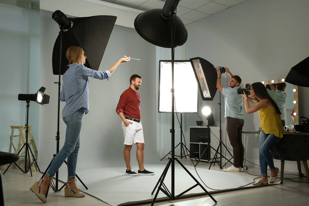 Professional team working with model in photo studio - Foto, Imagem
