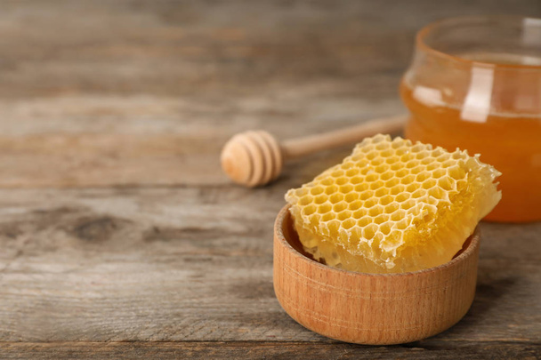 Tasty fresh honeycomb in bowl on wooden table - Photo, Image