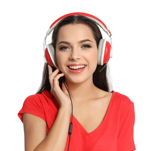 Young woman listening to Christmas music on white background - Photo, image