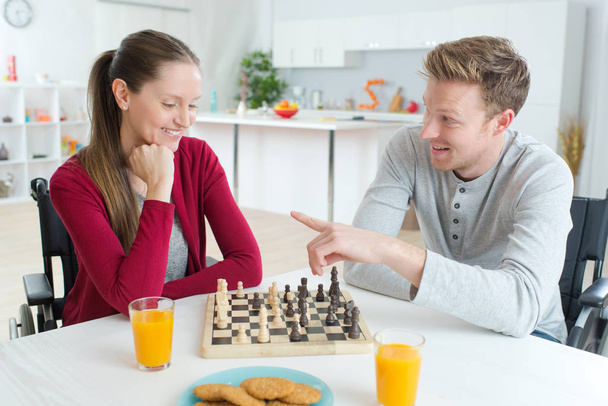focused happy couple playing chess in the kitchen - Фото, зображення