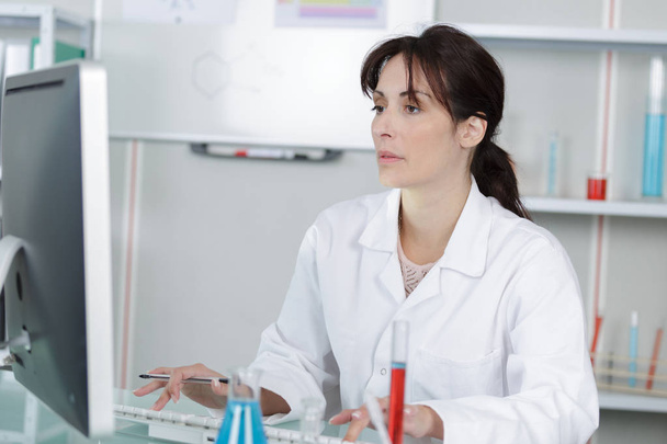 portrait of a pharmacist checking the prescription and medication - Photo, Image