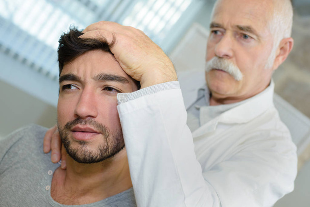 man receiving head massage in medical office - Fotografie, Obrázek