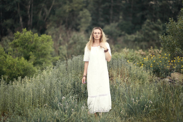 beautiful blonde woman in white dress on nature - Fotoğraf, Görsel