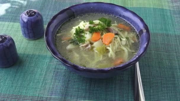 Chicken noodle soup - broth. Traditional chicken soup served in a bowl. - Footage, Video