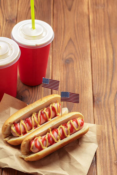 Hot dogs with usa flags on wooden background  - Фото, зображення