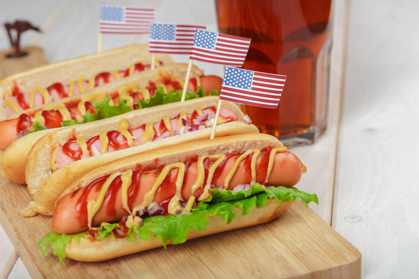 Hot dogs with usa flags on wooden background  - Foto, immagini
