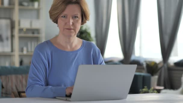Thumbs Down by Old Senior Woman Looking at Camera at Work - Footage, Video