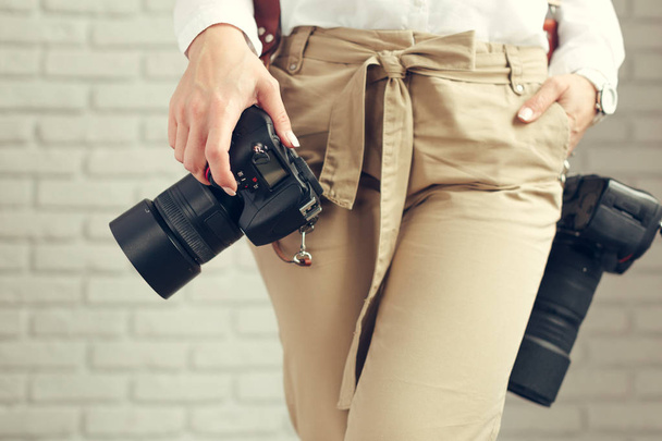 Pretty woman is a professional photographer with dslr camera - Photo, image