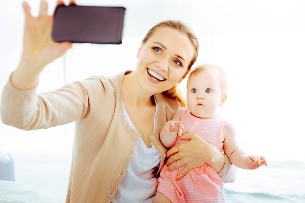 Happy young mother doing photo - Photo, Image
