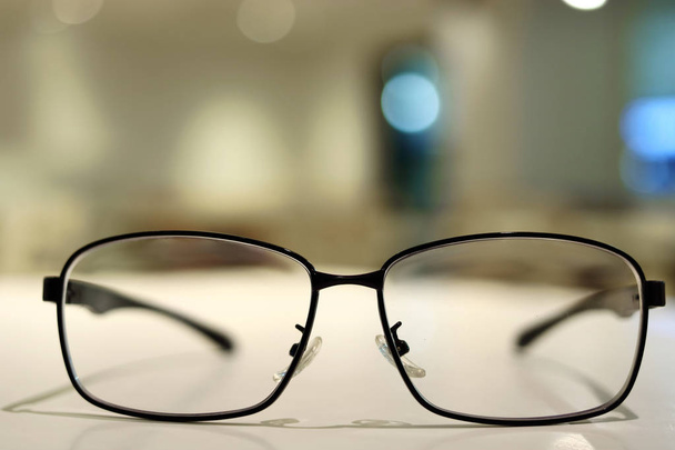 Glasses on the desk with bokeh background. - 写真・画像