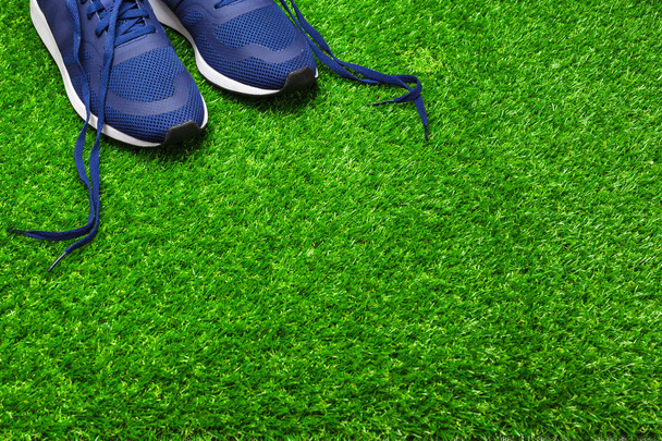 Sport shoes on grass - Foto, afbeelding