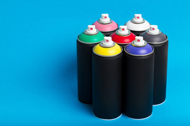 spry bottles on color background, street art concept  - Foto, Imagen