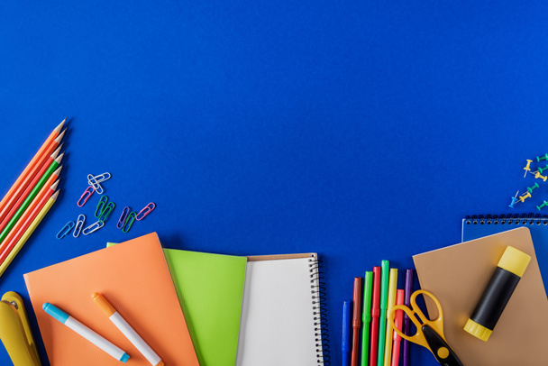 top view of empty textbook and variety stationery on blue background  - Photo, Image