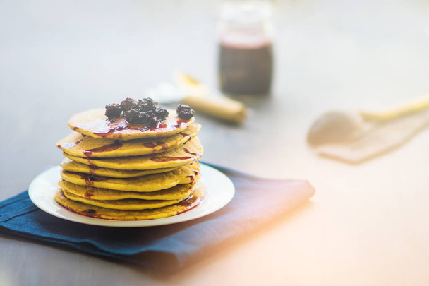 Delicious golden pancakes with fresh blackberries and blackberry jam , light toning - Photo, Image
