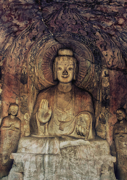 Luoyang, Hernan, China-December 25,2017 : A carved stone Buddha, carved from the rock, Longmen Grottoes and Caves, Luoyang, Henan Province, China - Photo, Image