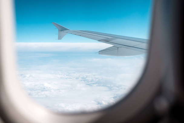 Clouds and sky as seen through window of an airplane. - Φωτογραφία, εικόνα