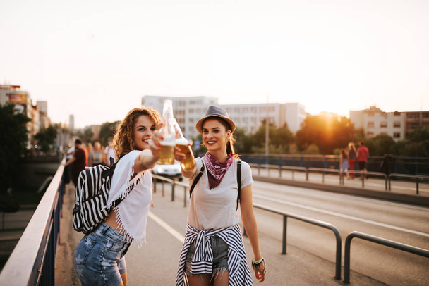 Festival girls drinking and having fun in the summer. - Foto, Imagem