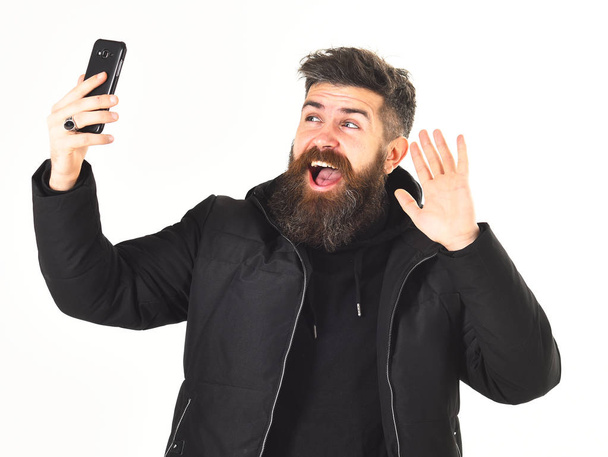 Blogger with beard takes selfie photo or streaming video. - Fotografie, Obrázek