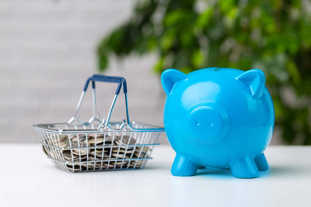 piggy bank with shopping cart on the table - Foto, Imagen