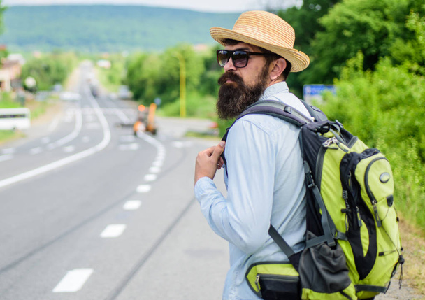 Missed his bus. Tips of experienced traveler. Man bearded hipster tourist at edge of highway. Pick me up. Traveler waiting for car take him anyway just to drop at better spot - Photo, Image