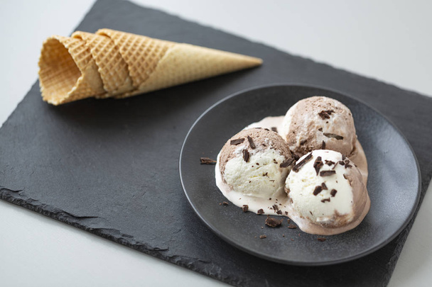 Chocolate and vanilla ice cream, waffle cones, dark stone background - Φωτογραφία, εικόνα