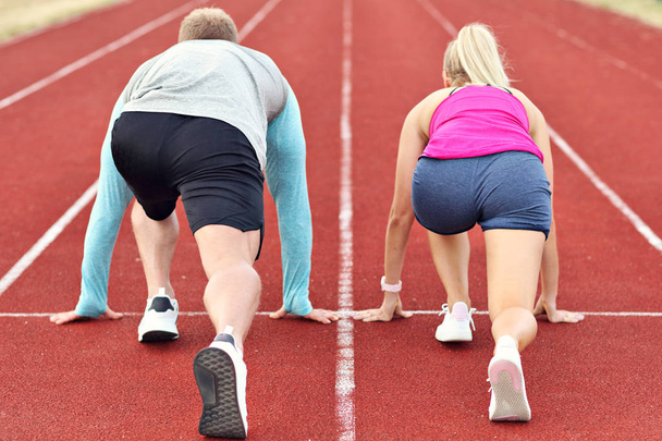 Man and woman racing on outdoor track - Foto, Imagem