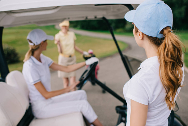 partial view of female golf players in caps at golf course - 写真・画像