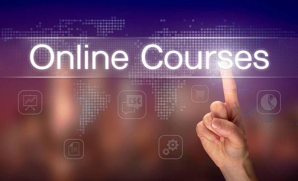 Male hand selecting Online Courses button on clear screen with blurred background - Photo, Image