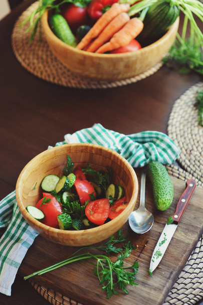 fresh salad with cucumbers and tomatos picked from farm garden. Seasonal summer harvest. - Fotó, kép